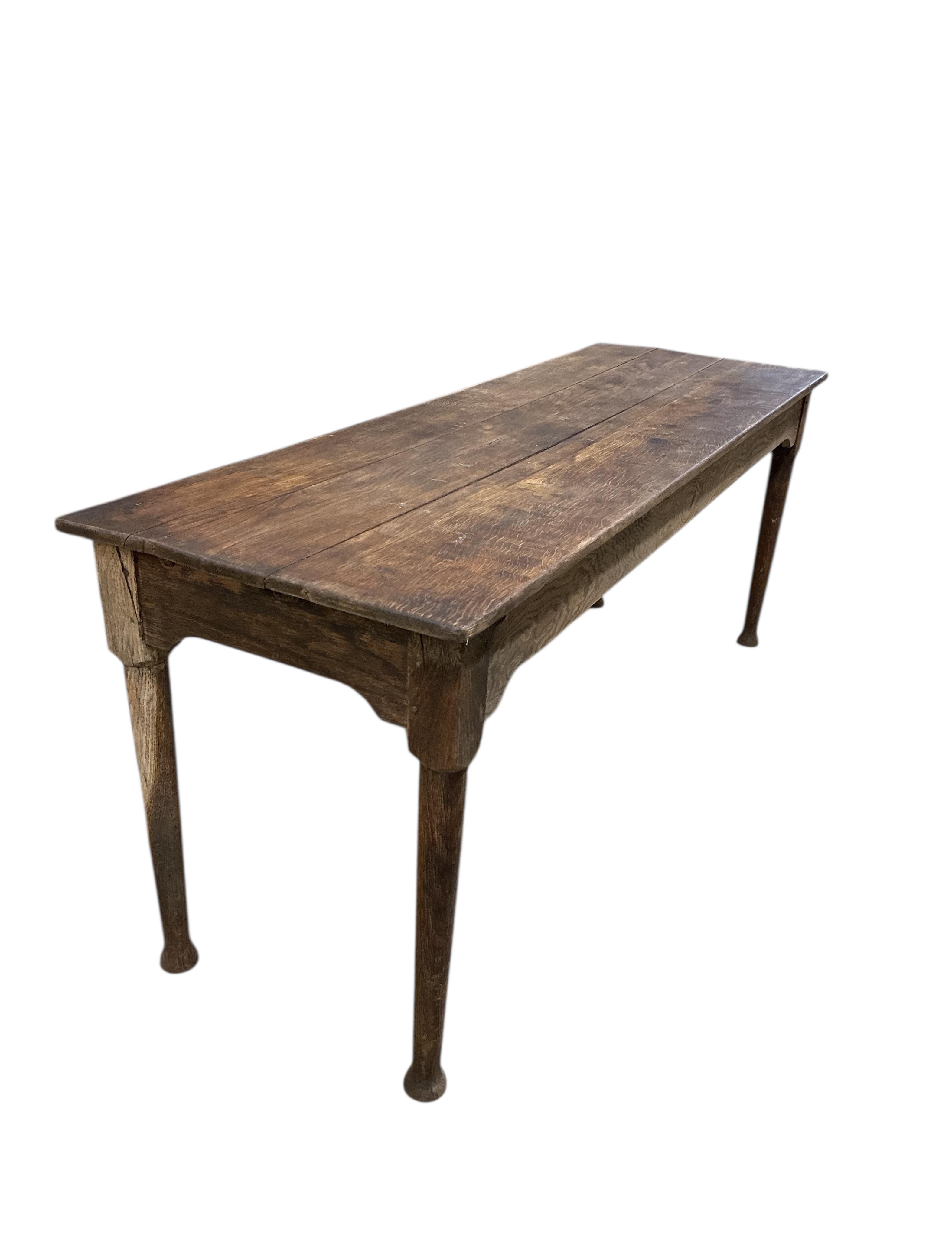 A 19th century rectangular oak plank topped dining table, width 183cm, depth 60cm, height 73cm